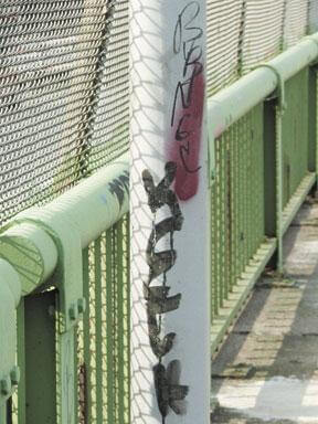Footbridge covered by graffiti tags