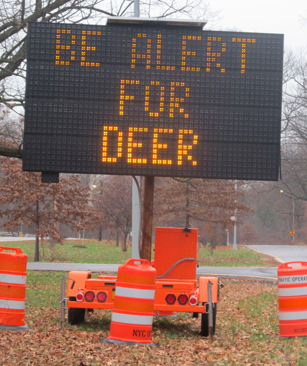 Electric sign in Pelham Bay Park warns of deer crossings