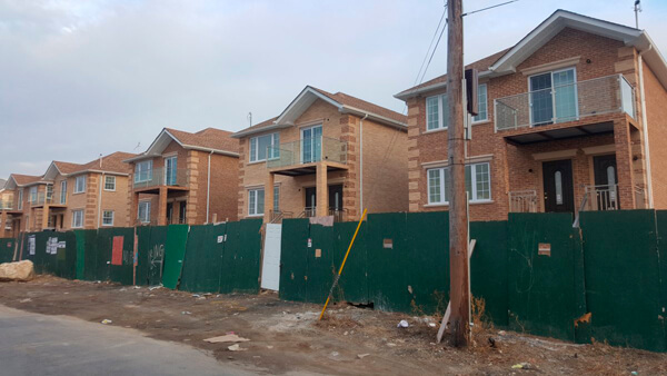 Two-family homes being built on Miles Avenue