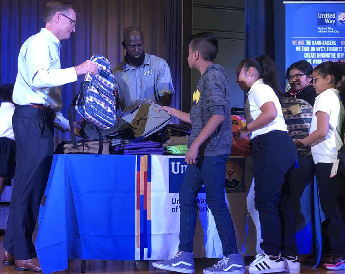 NY Giants safety Michael Thomas joins PS 49’s backpack giveaway