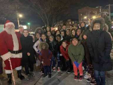 Allerton International Merchants Association Christmas Tree Lighting attended by Biaggi