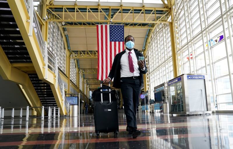 FILE PHOTO: Passenger walks through Reagan National airport as air travel continues to be minimal in Washington