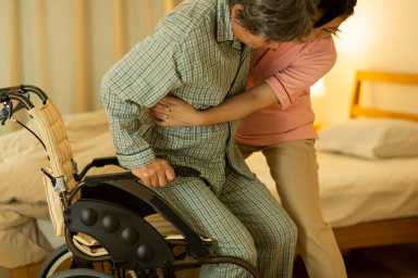 Carer caring for senior man