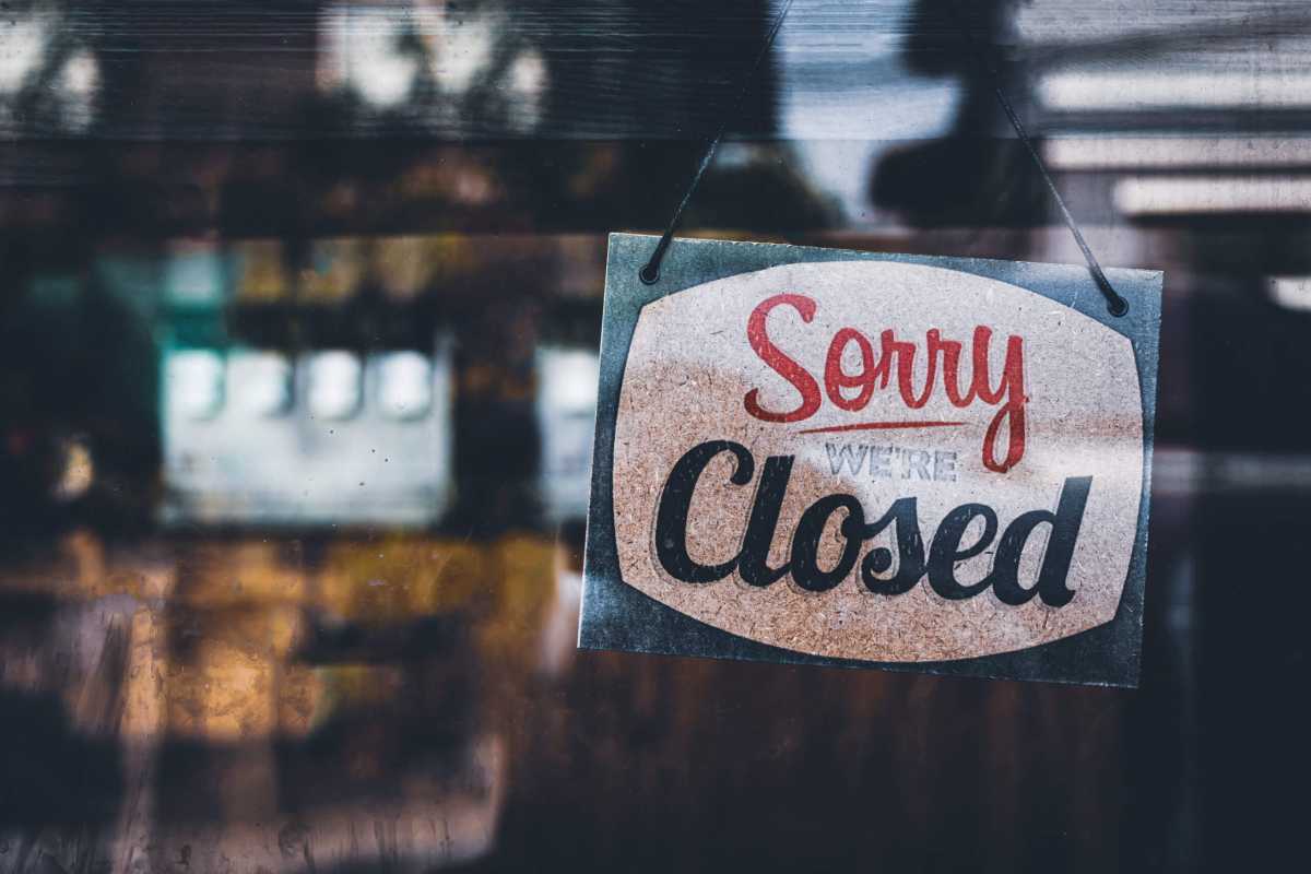 Sorry we’re closed . grunge image hanging on a cafe window, Coronavirus COVID-19 outbreak lockdown.