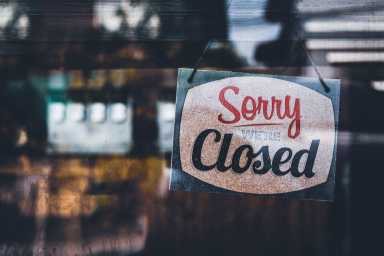 Sorry we’re closed . grunge image hanging on a cafe window, Coronavirus COVID-19 outbreak lockdown.