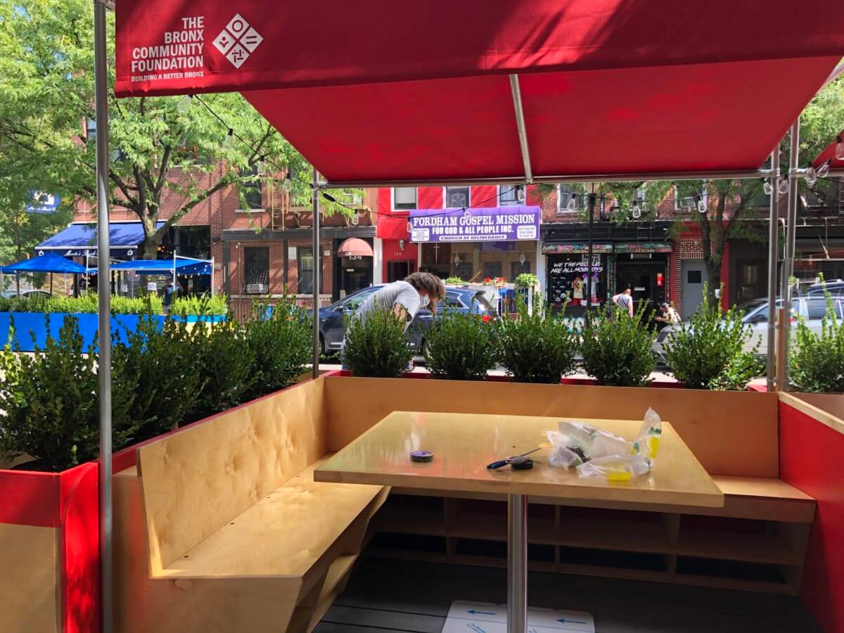 PHOTOS: Volunteers build outdoor seating as in-street dining comes to