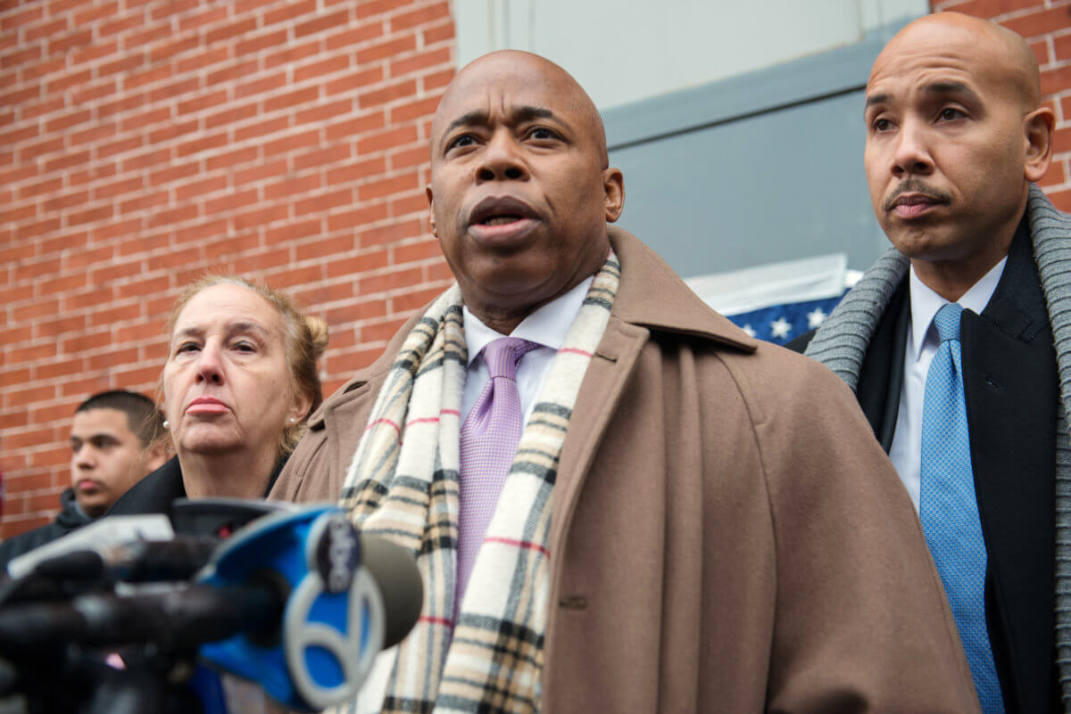 Borough presidents speak during a news conference at the scene where two police officers were fatally shot in Brooklyn