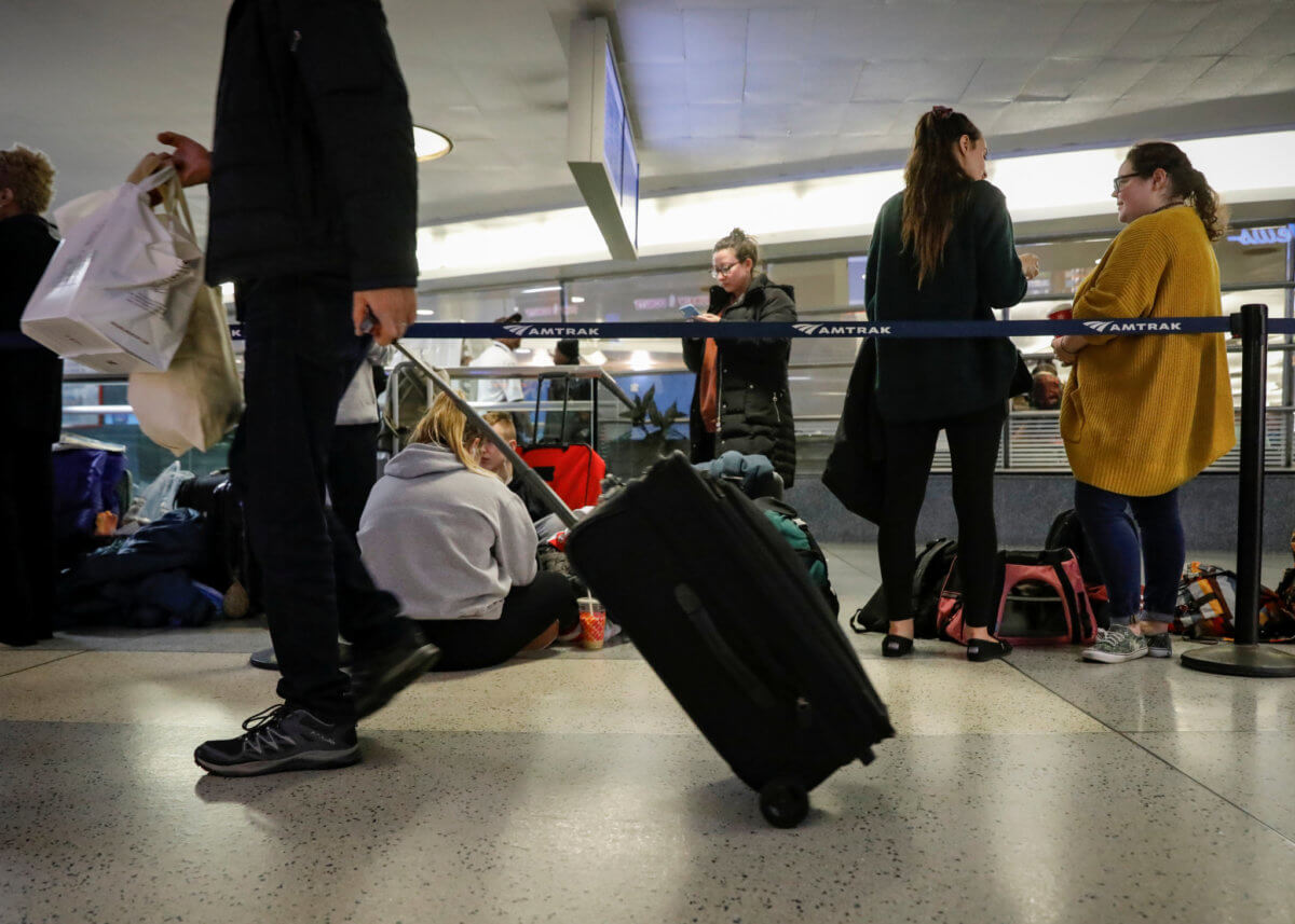 Travelers move through the boarding area for trains during the Thanksgiving holiday travel rush at Pennsylvania Station in New York