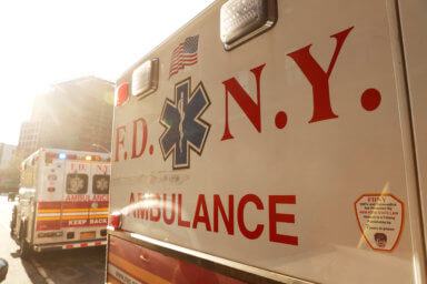 FDNY ambulances stand outside after the EMT went inside building to assist woman having difficulty breathing during ongoing outbreak of coronavirus disease (COVID19) in New York