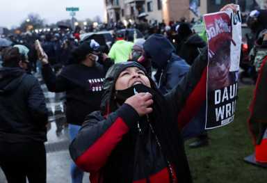 FILE PHOTO: Protesters rally outside Brooklyn Center Police Department a day after Daunte Wright was shot and killed by a police officer, in Brooklyn Center, Minnesota