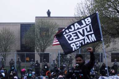 Protesters rally outside the Brooklyn Center Police Department, days after Daunte Wright was shot and killed by a police officer, in Brooklyn Center, Minnesota