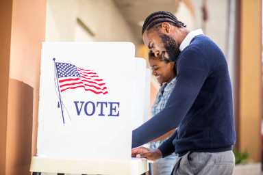Millenial Black Man and Woman Voting in Election