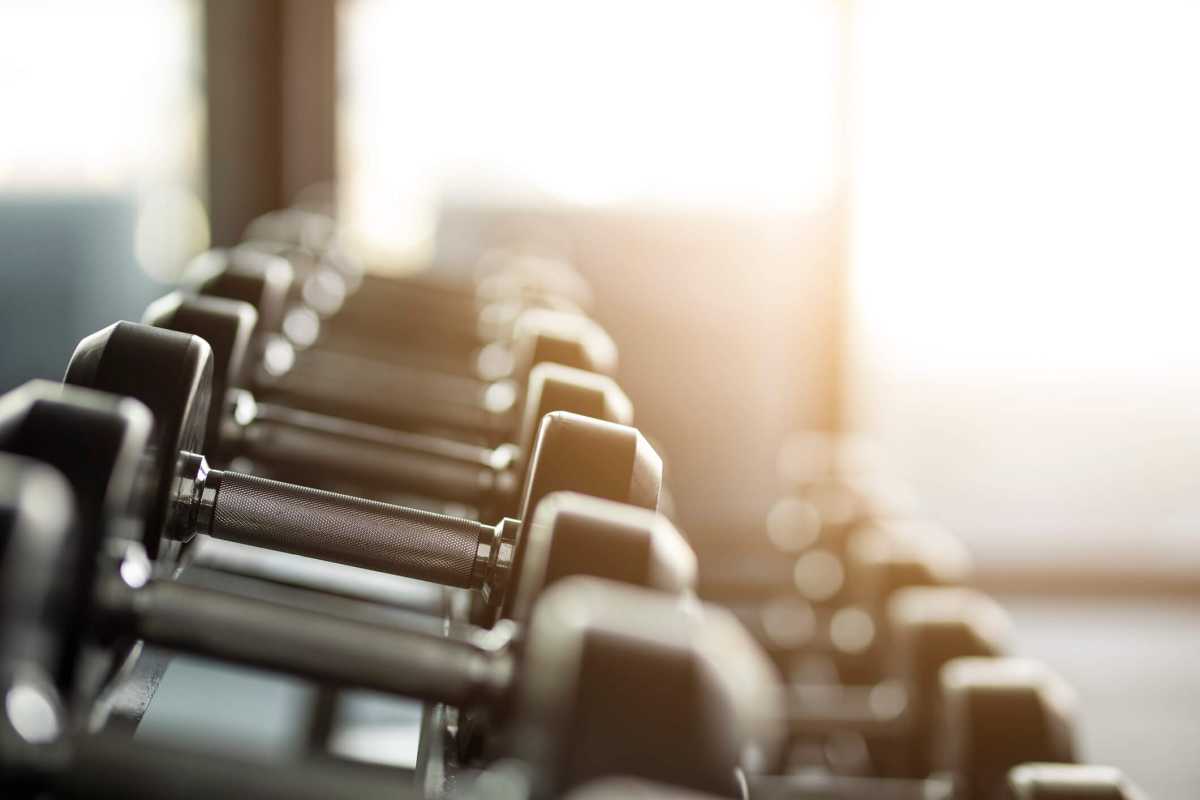 Gym background with Fitness equipment dumbbells weight for workout