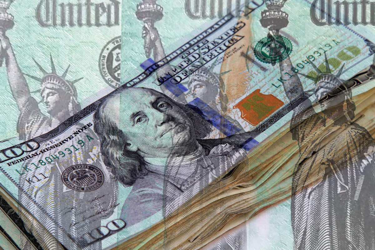 Federal treasury checks over stack of US currency