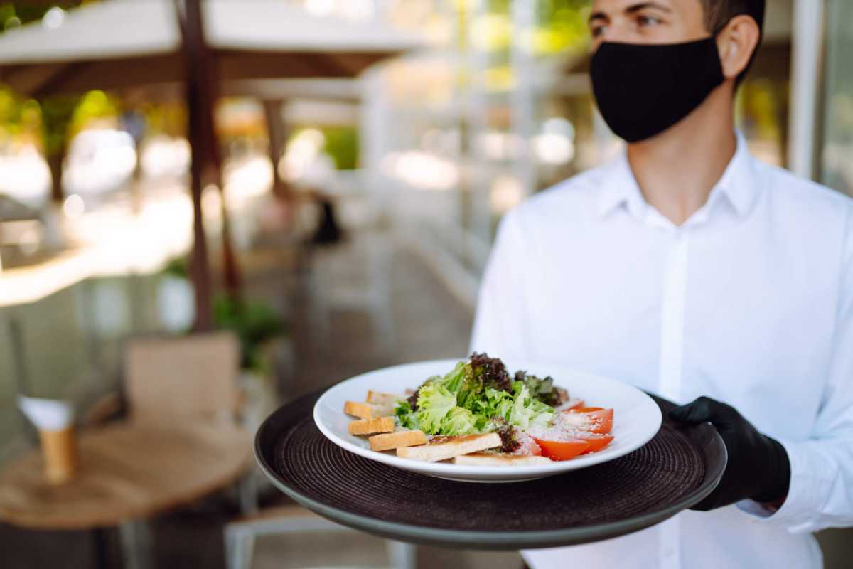 Salad on a waiter’s tray. Covid- 2019.