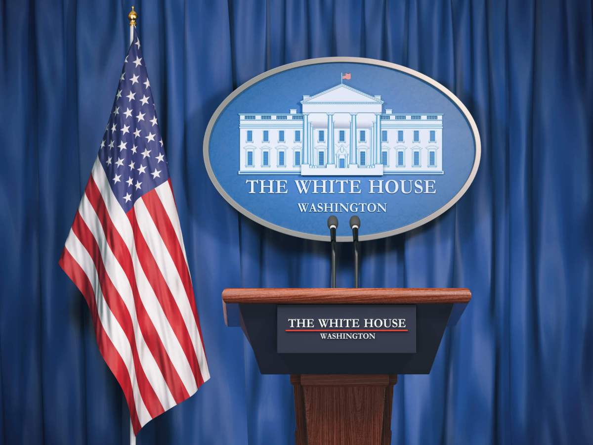 Politics of White House and President of USA United states concept.  Podium speaker tribune with USA flags and sign of White House