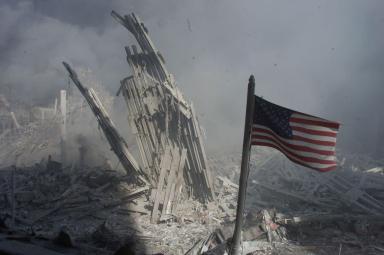 AMERICAN FLAG FLIES AS WORLD TRADE CENTER SMOKE AND DUST LINGERS INAIR.