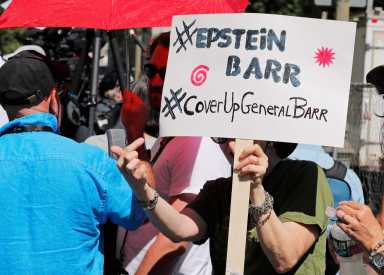 A protester holds up a sign outside the courthouse ahead  of a bail hearing in U.S. financier Jeffrey Epstein’s sex trafficking case in New York City