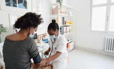 Female doctor checking the patient’s blood pressure