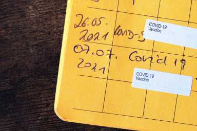fully vaccinated with proof of two covid-19 vaccines in yellow vaccination certificate