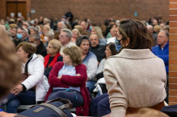 Councilmember Marjorie Velázquez sits in front of a crowd of residents