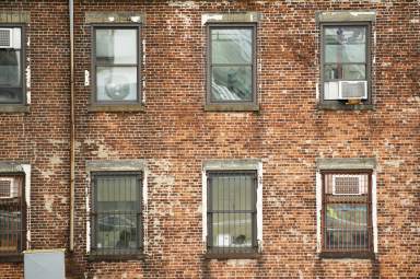 Close-up view of windows of some apartments. Photo taken from the Brooklyn Bridge in Manhattan, New York, USA.