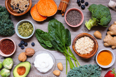 Group of healthy food ingredients. Overhead view table scene on a wooden background.