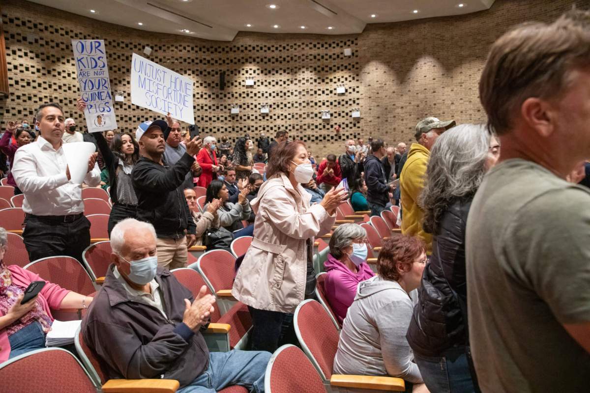 people in the audience of a community board 11 public heariing