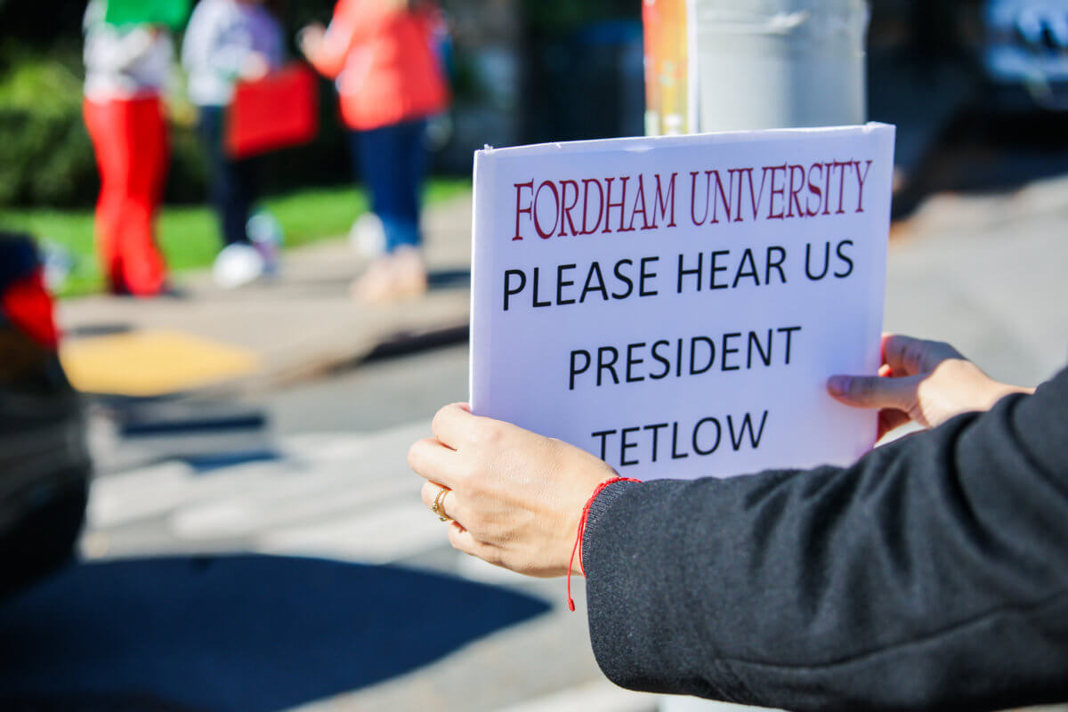 Community members protest Fordham University's updated COVID-19 bivalent vaccine mandate.