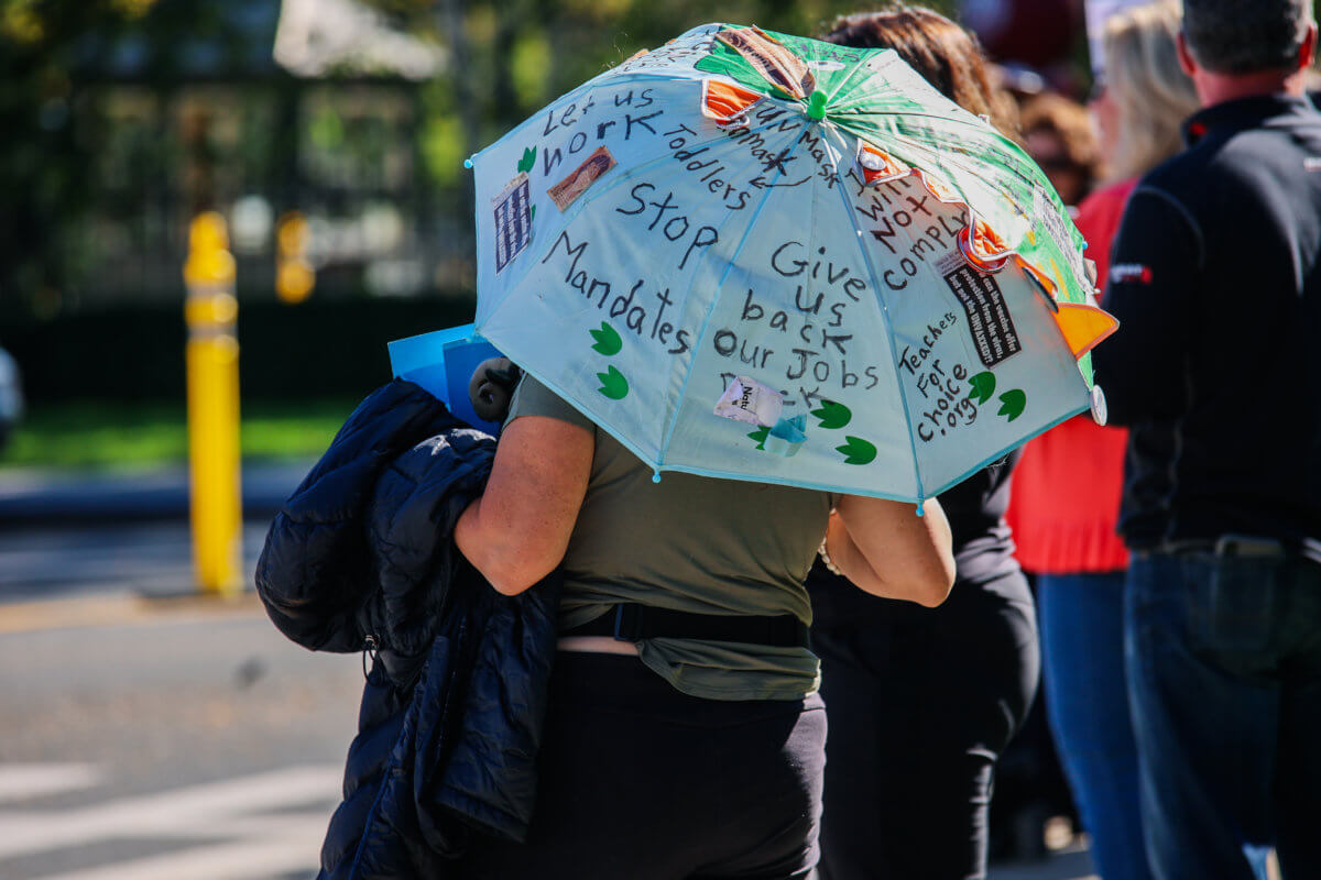 Community members protest Fordham University's updated COVID-19 bivalent vaccine mandate.