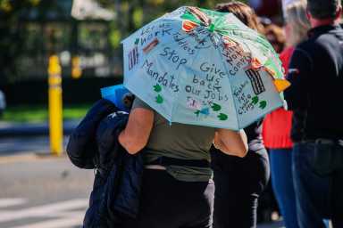 Community members protest Fordham University's updated COVID-19 bivalent vaccine mandate.