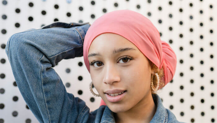 beautiful woman with a pink cancer fighter scarf