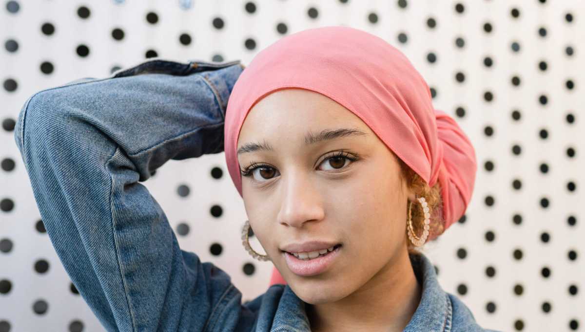 beautiful woman with a pink cancer fighter scarf