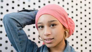 beautiful woman with a pink cancer fighter scarf