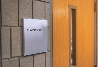 Classroom door with sign at school