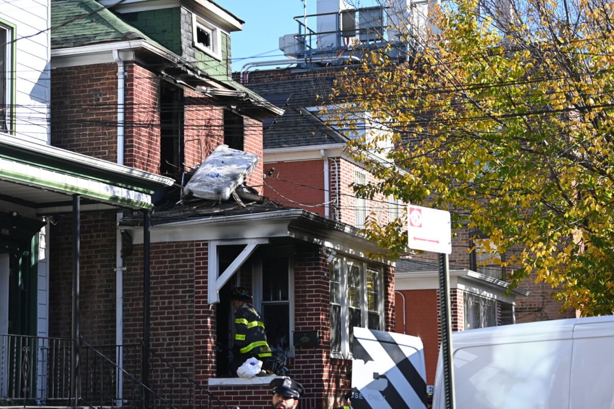Firefighters at the Quimby Street home in the Bronx that caught fire on Oct. 30, 2022 and killed four residents.