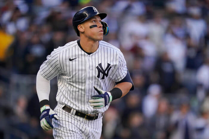 New York Yankees' Aaron Judge watches his solo home run ball during the second inning of Game 5 of an American League Division baseball series against the Cleveland Guardians, Oct. 18, 2022, in New York. 