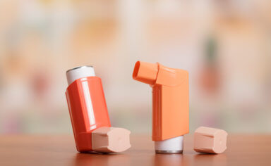 Two small pocket inhaler to relieve an asthma attack, on table