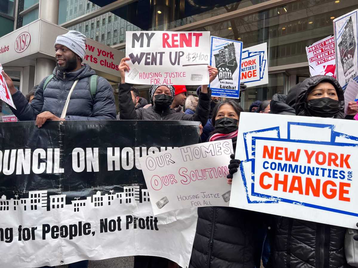 protestors hold signs