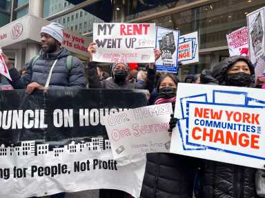 protestors hold signs