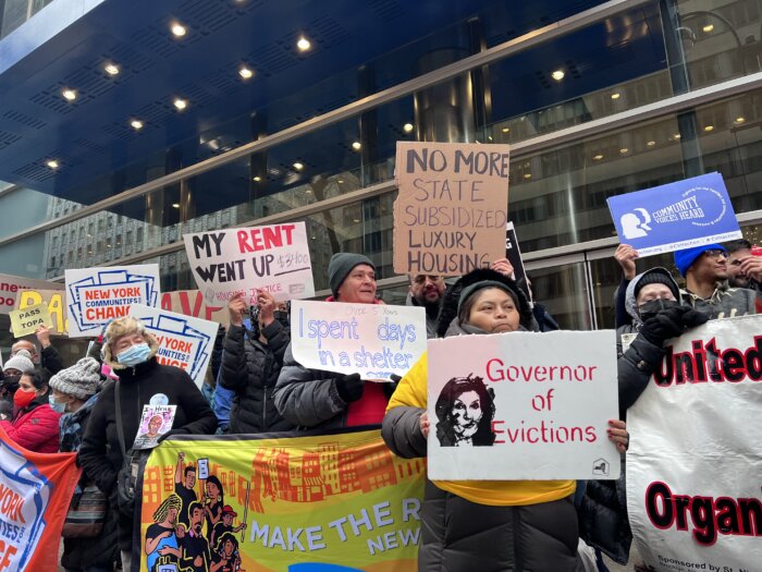 protestors hold signs