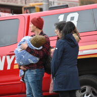 People watch on as firefighters work to bring the blaze under control in Soundview on Sunday, Jan. 29, 2023.
