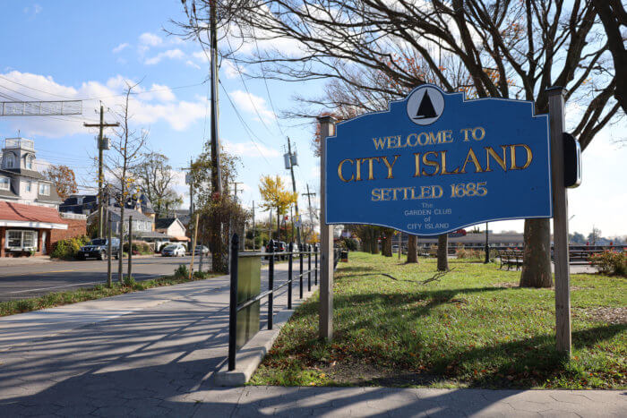 A City Island sign greets visitors at the only entrance and exit to the small enclave on Thursday, March 26, 2023.