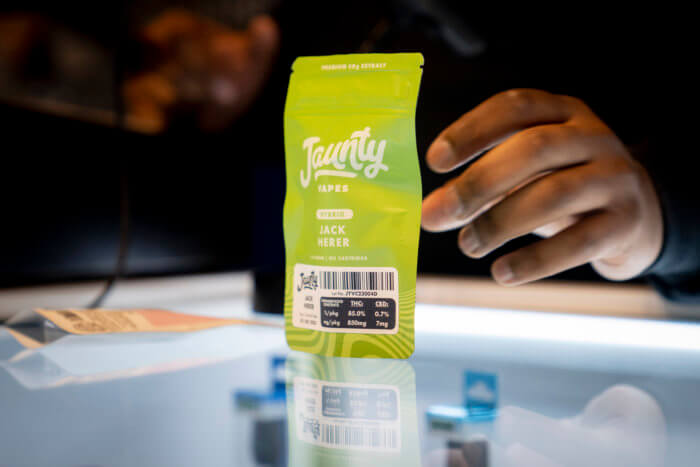 Darius Conner prepares to make the first sale of vaporizer cartridges of cannabis in the "pop up" location of his family business Smacked, Tuesday, Jan. 24, 2023, in New York.