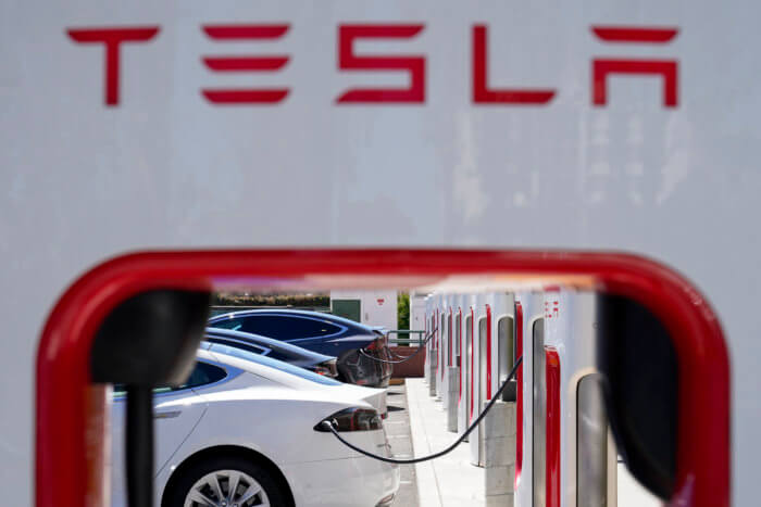 FILE - Tesla vehicles charge at a station in Emeryville, Calif., Aug. 10, 2022. Tesla will, for the first time, make some of its charging stations available to all U.S. electric vehicles, regardless of make, by the end of next year, under a new plan announced by the White House. The plan will make at least 7,500 chargers from Tesla's Supercharger and Destination Charger network available to non-Tesla EVs, by the end of 2024.(AP Photo/Godofredo A. Vásquez)