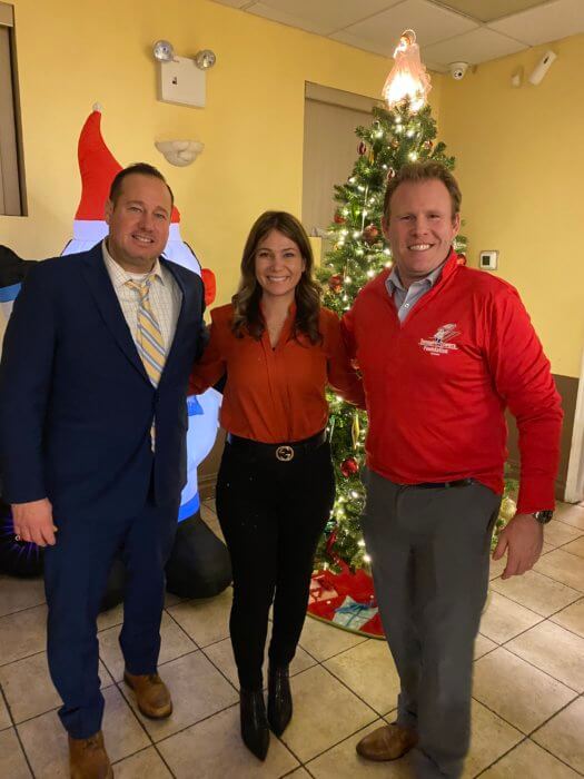 Kristy Marmorato with Michael Rendino and Andrew Giuliani in front of a Christmas tree