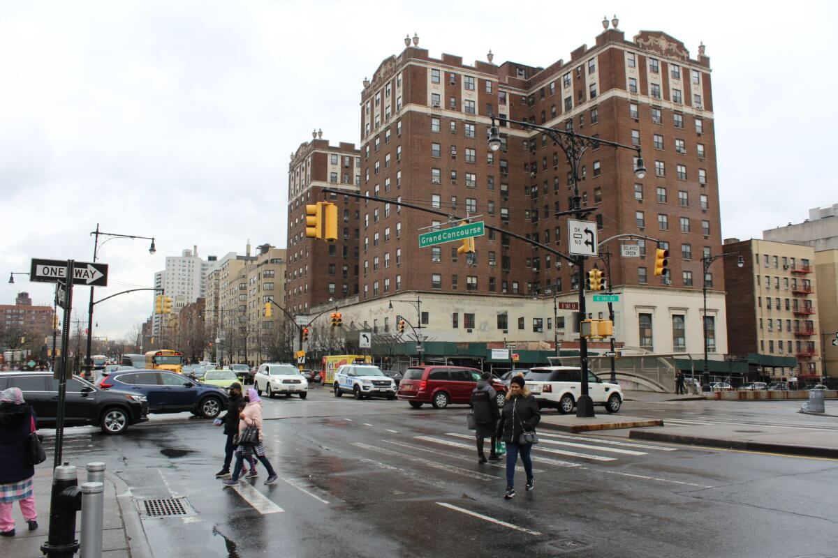 People walk along Grand Concourse in the Bronx on Friday, Feb. 17, 2023.