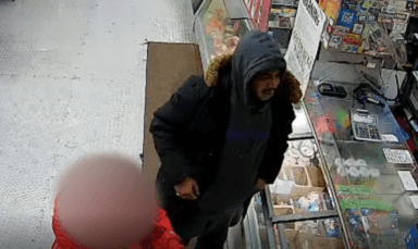 A surveillance photo shows a man who is wanted for shooting two men in a Highbridge robbery