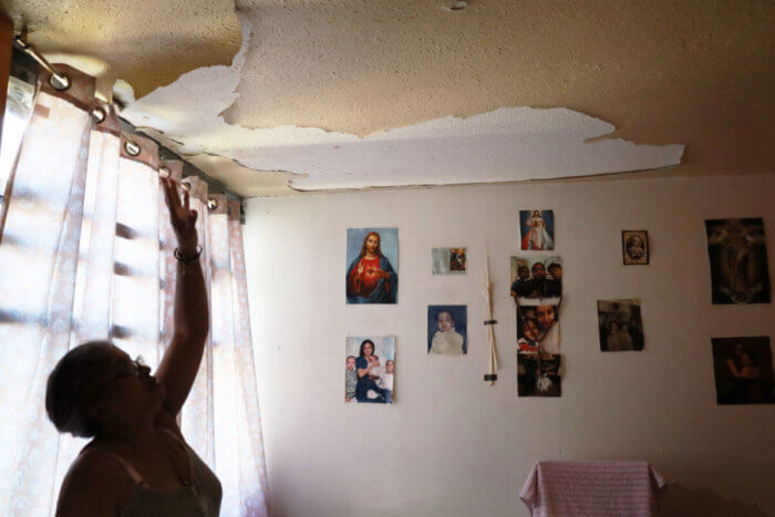 Chasmee Malave lives on the ninth floor of the NYCHA's Fort Independence Houses in Kingsbridge Heights and points to water damage to her ceiling sustained last year.