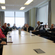 ICS and CLDR members and leadership sitting with Senator Rivera around a long table.
